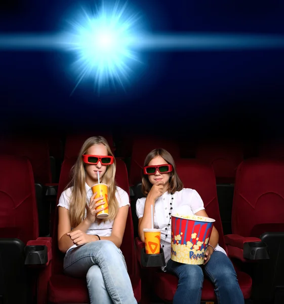 Two young girls in cinema — Stock Photo, Image