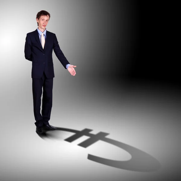 Бизнесмен с тенью в качестве символа валюты — стоковое фото