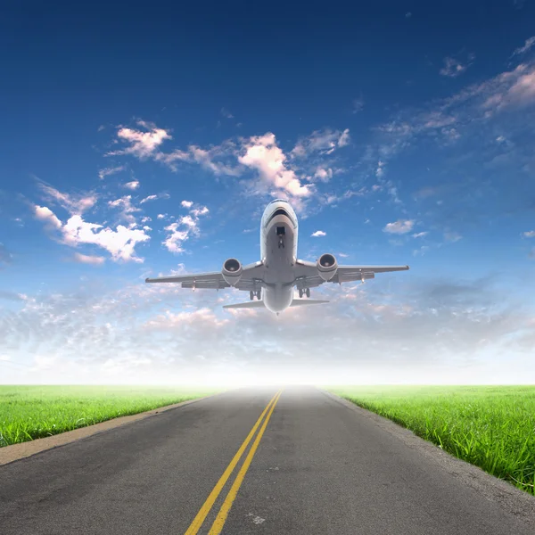 Airplane in blue cloudy sky — Stock Photo, Image