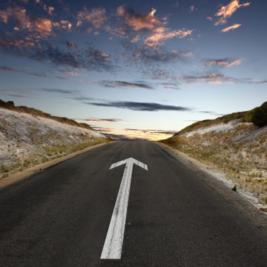 Empty countryside road with white arrow clipart