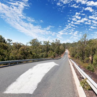 Empty countryside road with white arrow clipart