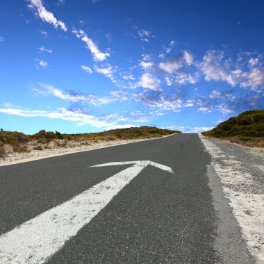 Empty countryside road with white arrow clipart