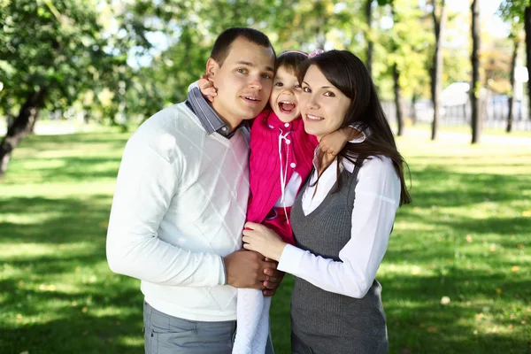 Young family with a child in summer park — Stock Photo, Image