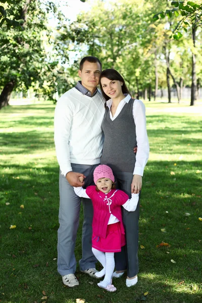 Mladá rodina s dítětem v letním parku — Stock fotografie