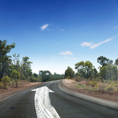 Empty countryside road with white arrow clipart