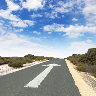 Empty countryside road with white arrow clipart