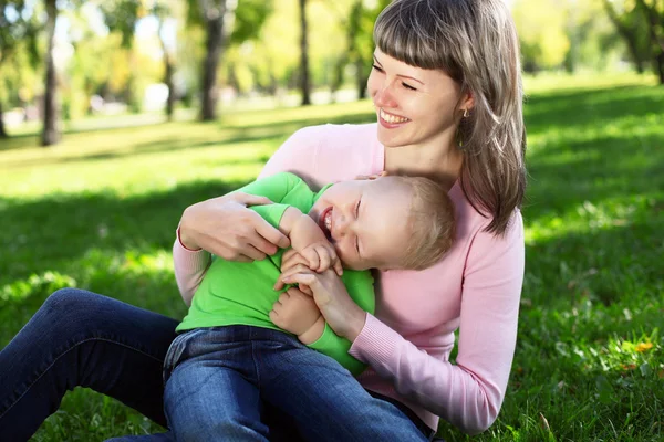 Young mother with her son in summer park Royalty Free Stock Images