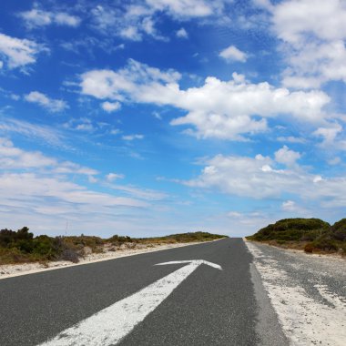 Empty countryside road with white arrow clipart