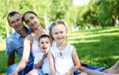 Family with two children in the summer park