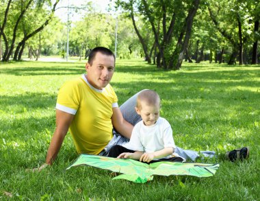 Father with his son in the park clipart