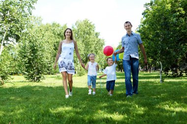 Family with two children in the summer park