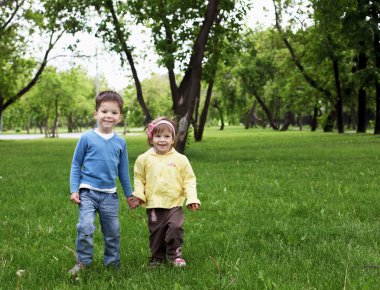 Happy sister and brother outdoors clipart