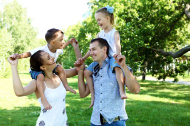 Family with two children in the summer park