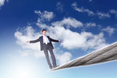 Business man balancing on the rope clipart