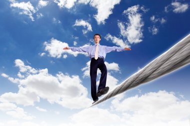 Business man balancing on the rope clipart