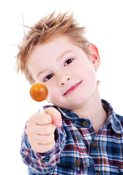 Close up of young boy eating a lollipop — Stock Photo, Image