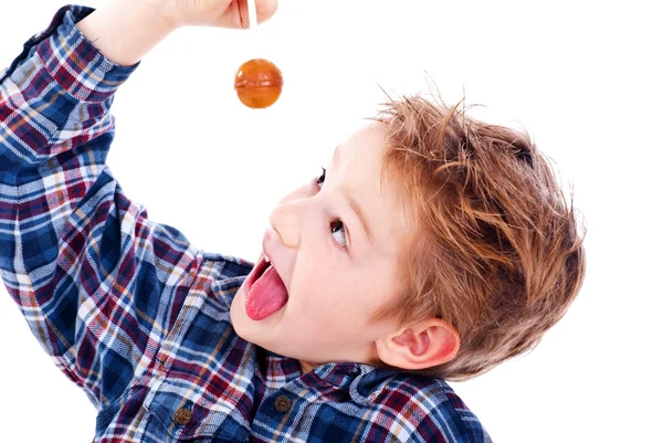 Close up of young boy eating a lollipop — Stock Photo, Image