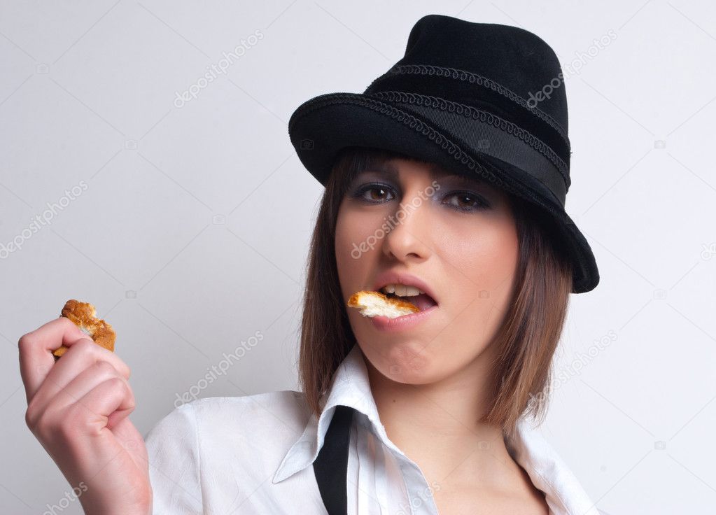 Young beautiful woman eating bread