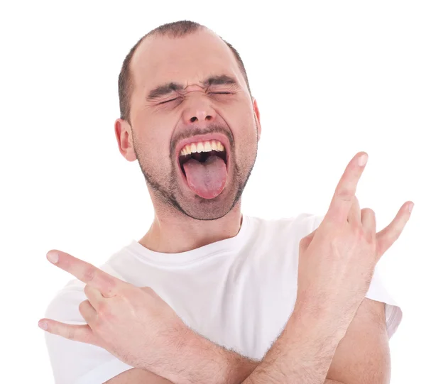 Portrait of young man singing and doing rock and roll symbol — Stock Photo, Image