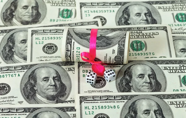 100 US dollar wrapped by ribbon on money background — Stock Photo, Image