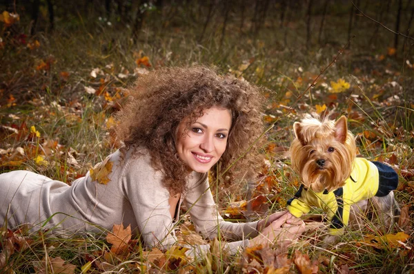 Young cheerful woman outdoors with a dog — Stock Photo, Image