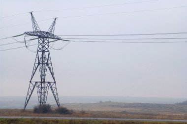 Electric power utility pole on cloudy sky clipart