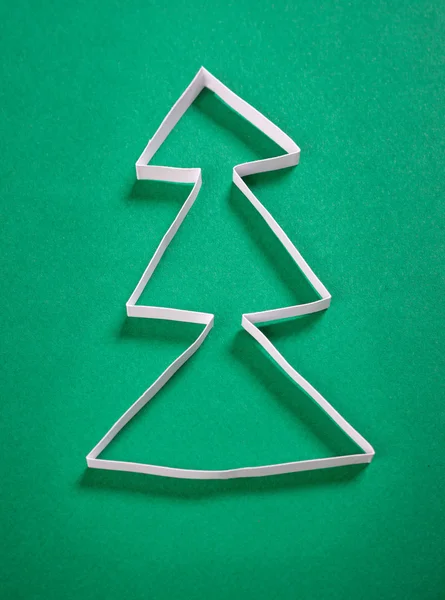 Paper christmas tree on green background — Stock Photo, Image