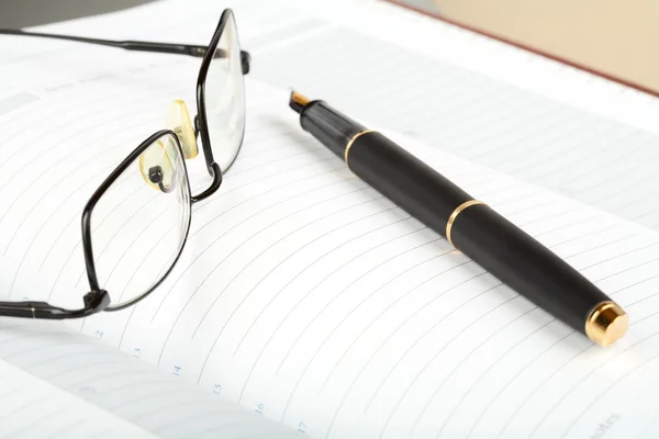 Business a still-life with fountain pen and glasses — Stock Photo, Image