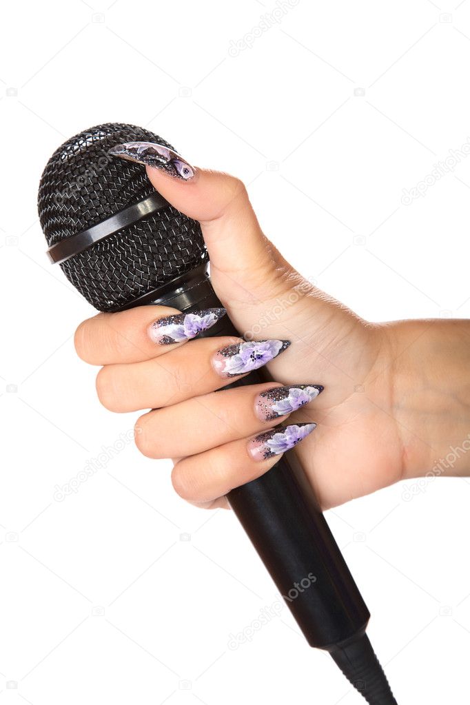 Female hand with manicure holds microphone isolated