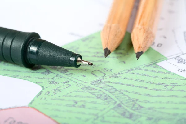 Pencils and marker on a map — Stock Photo, Image