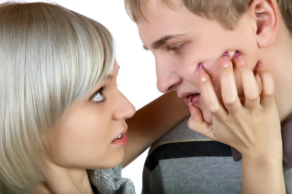 Girl sticks nails into face to the young man — Stock Photo, Image