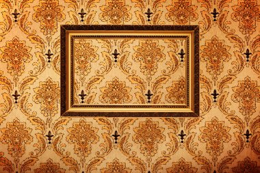 Vintage gold plated picture frame on retro wallpaper clipart