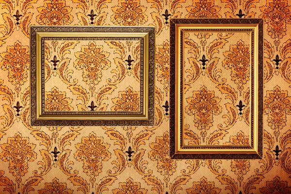 Vintage gold plated picture frames on retro wallpaper — Stock Photo, Image