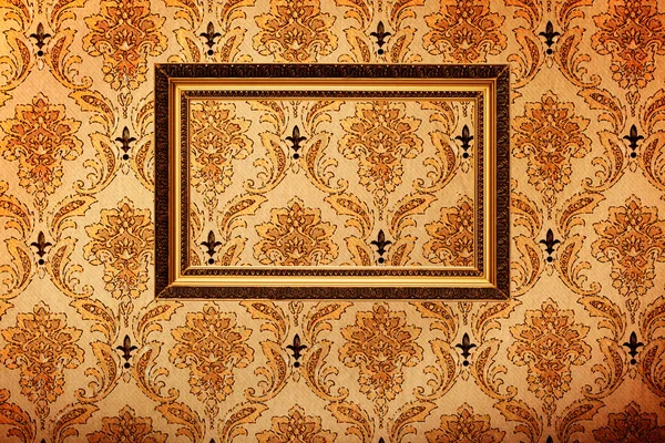 Vintage gold plated picture frame on retro wallpaper — Stock Photo, Image