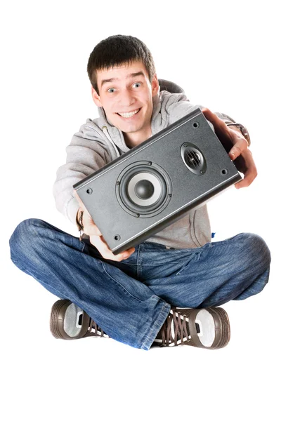 Smiling young man with a speaker — Stock Photo, Image