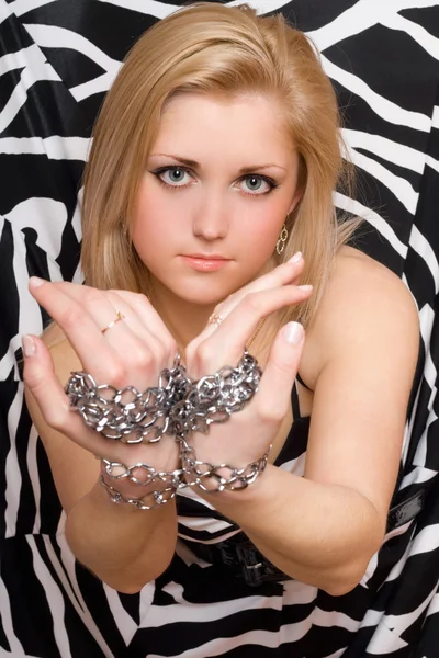 Sexy blonde stretches out her hands in chains — Stock Photo, Image