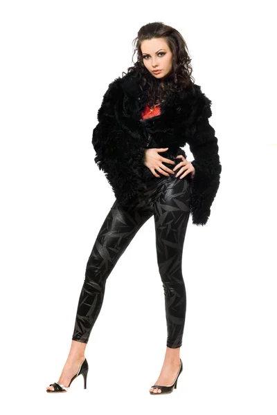 Sexy giovane bruna in cappotto nero e leggings — Foto Stock