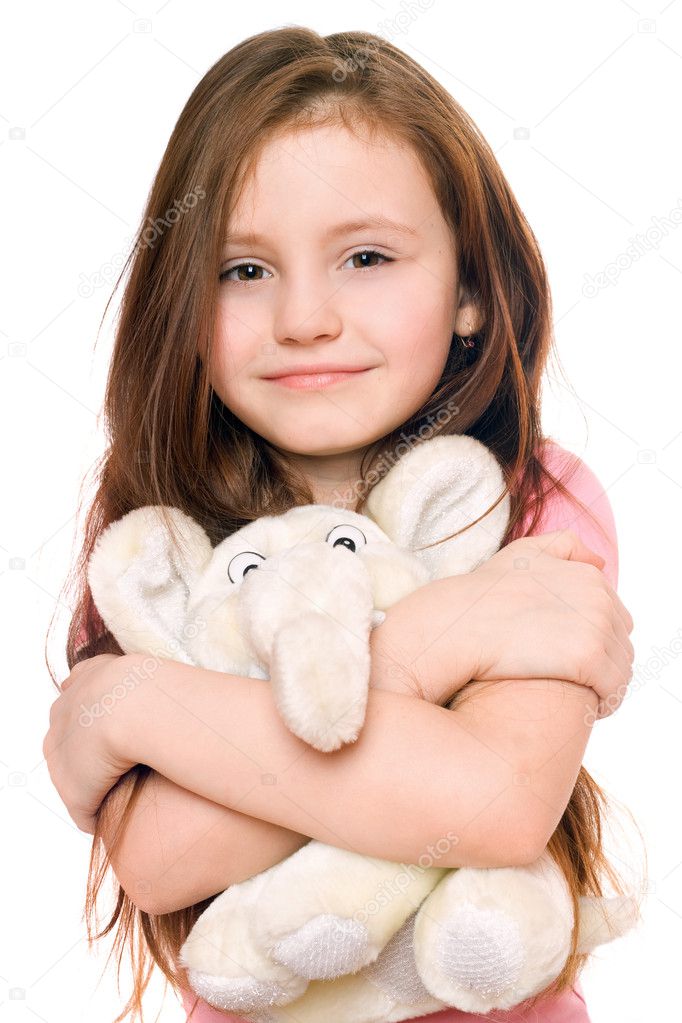 Portrait of smiling little girl with a teddy elephant