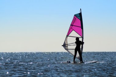 Silhouette of a girl windsurfer clipart