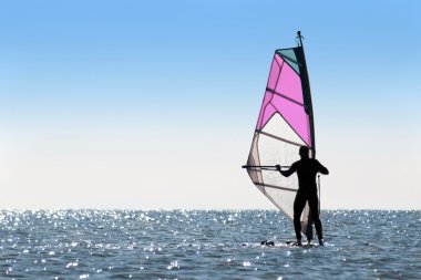 Silhouette of a woman windsurfer clipart