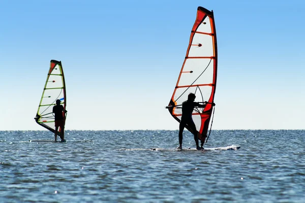 Silhouette of a two windsurfers — Stock Photo, Image