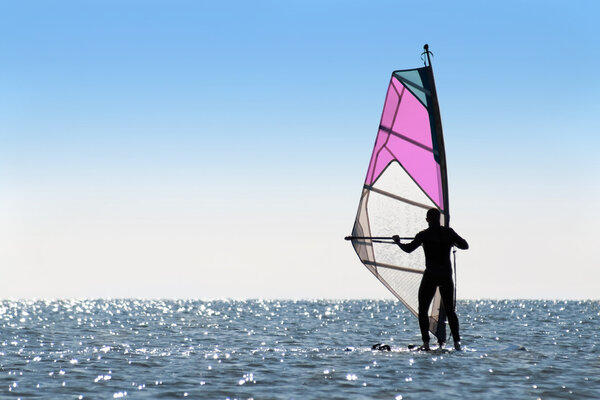 Silhouette of a woman windsurfer