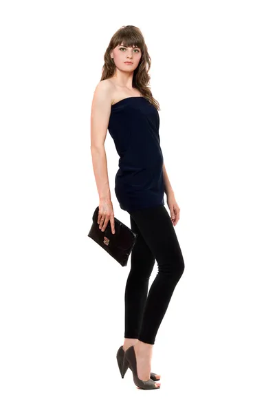 Vacker flicka i svarta leggings med en handväska — Stockfoto