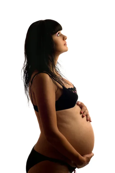 Gravid ung brunett i svart underkläder — Stockfoto