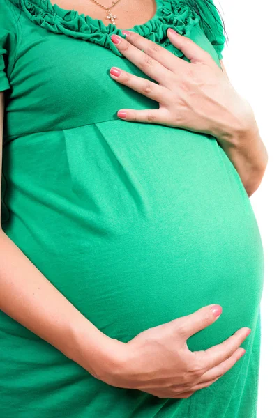 Buik van een zwangere meisje in groene jurk. geïsoleerd — Stockfoto