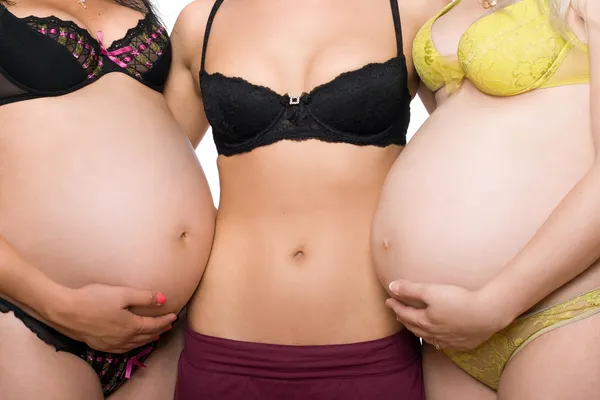 Üç kadın mide. izole — Stok fotoğraf