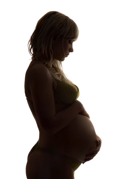 Sylwetka młodą kobietę w ciąży. na białym tle — Zdjęcie stockowe