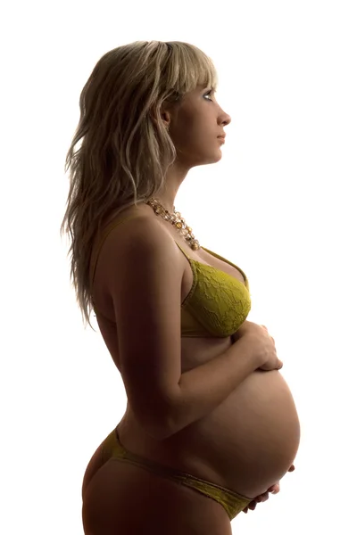 Młoda kobieta w ciąży w żółty bielizna — Zdjęcie stockowe
