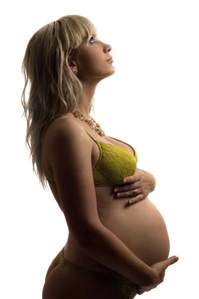 Zwangere jonge vrouw in gele lingerie. geïsoleerd — Stockfoto