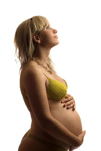Szczęśliwy w ciąży młoda kobieta w żółty bielizna — Zdjęcie stockowe